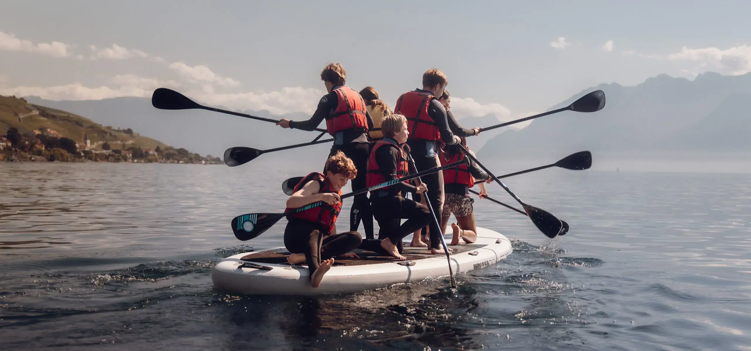 Students paddle boarding in the lake