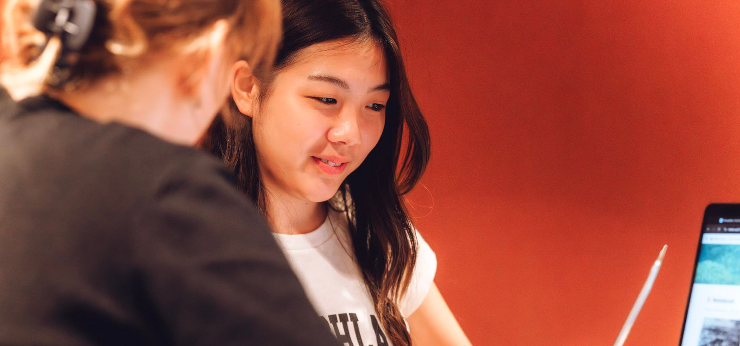 Teacher showing student the lesson in a laptop