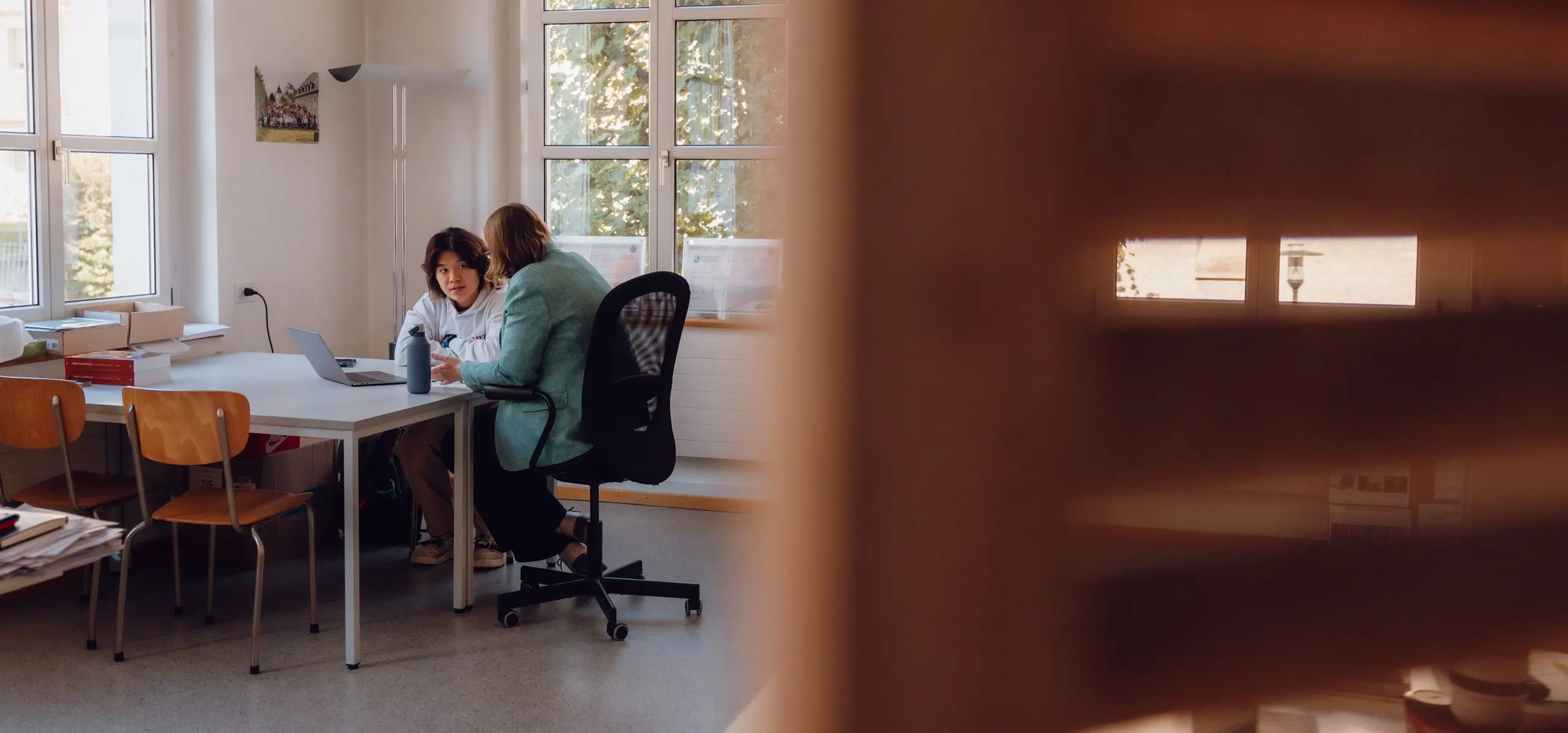 Student having a conversation with his teacher
