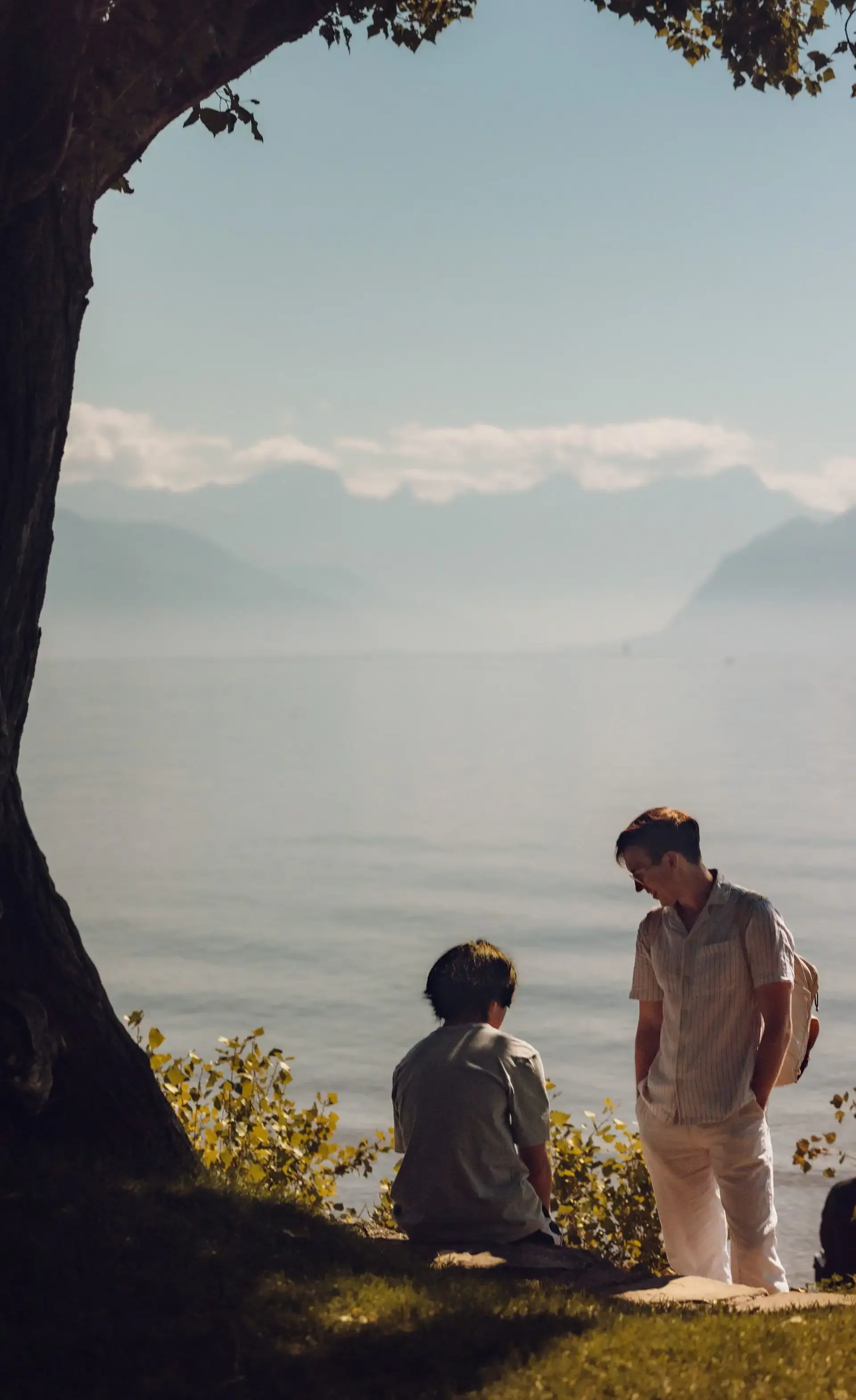 Students sharing tranquil moment by the water