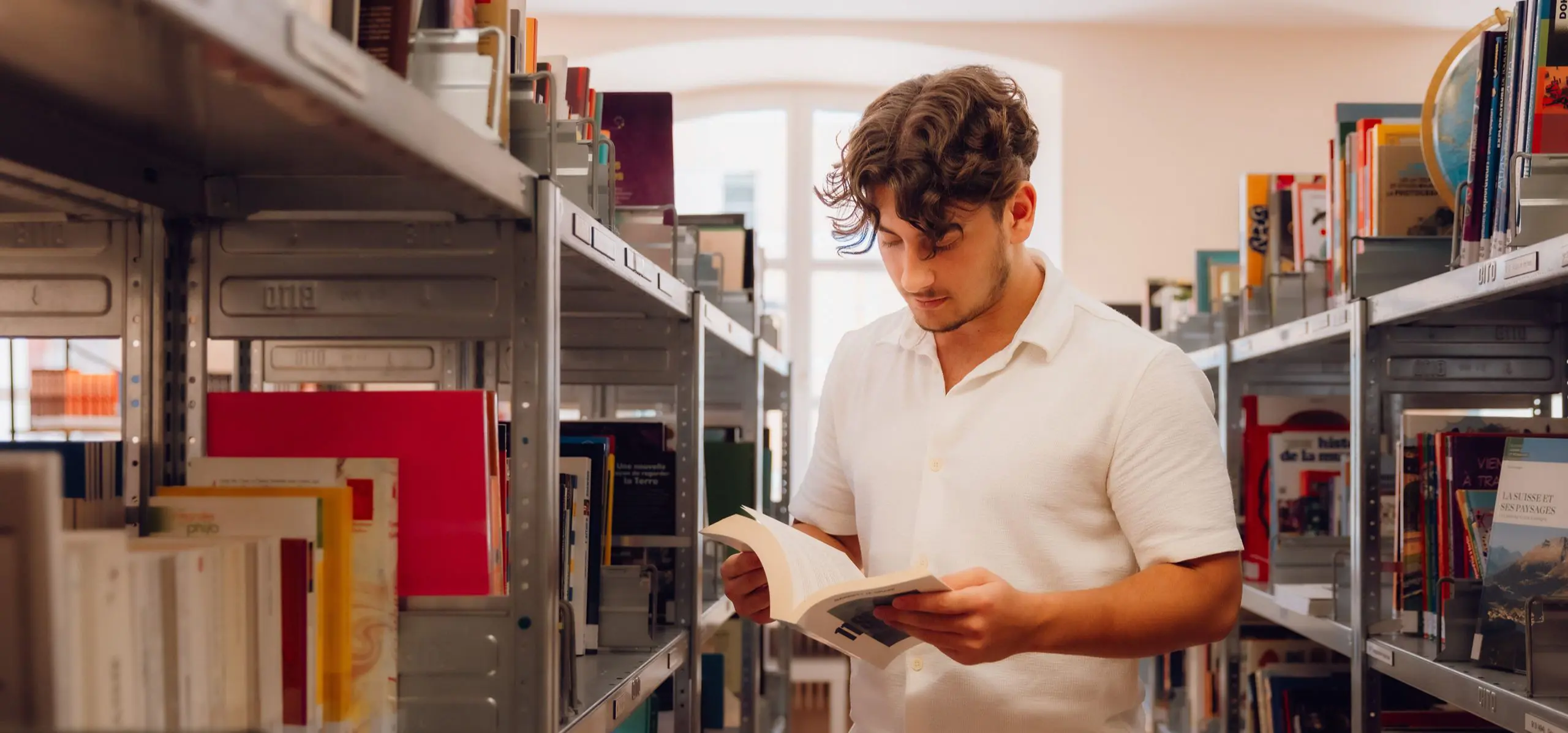 Student in the library reading a book