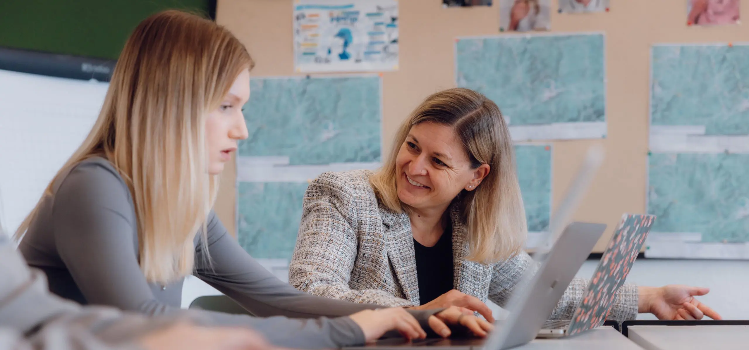 Teacher smiling to the students sitting next to her