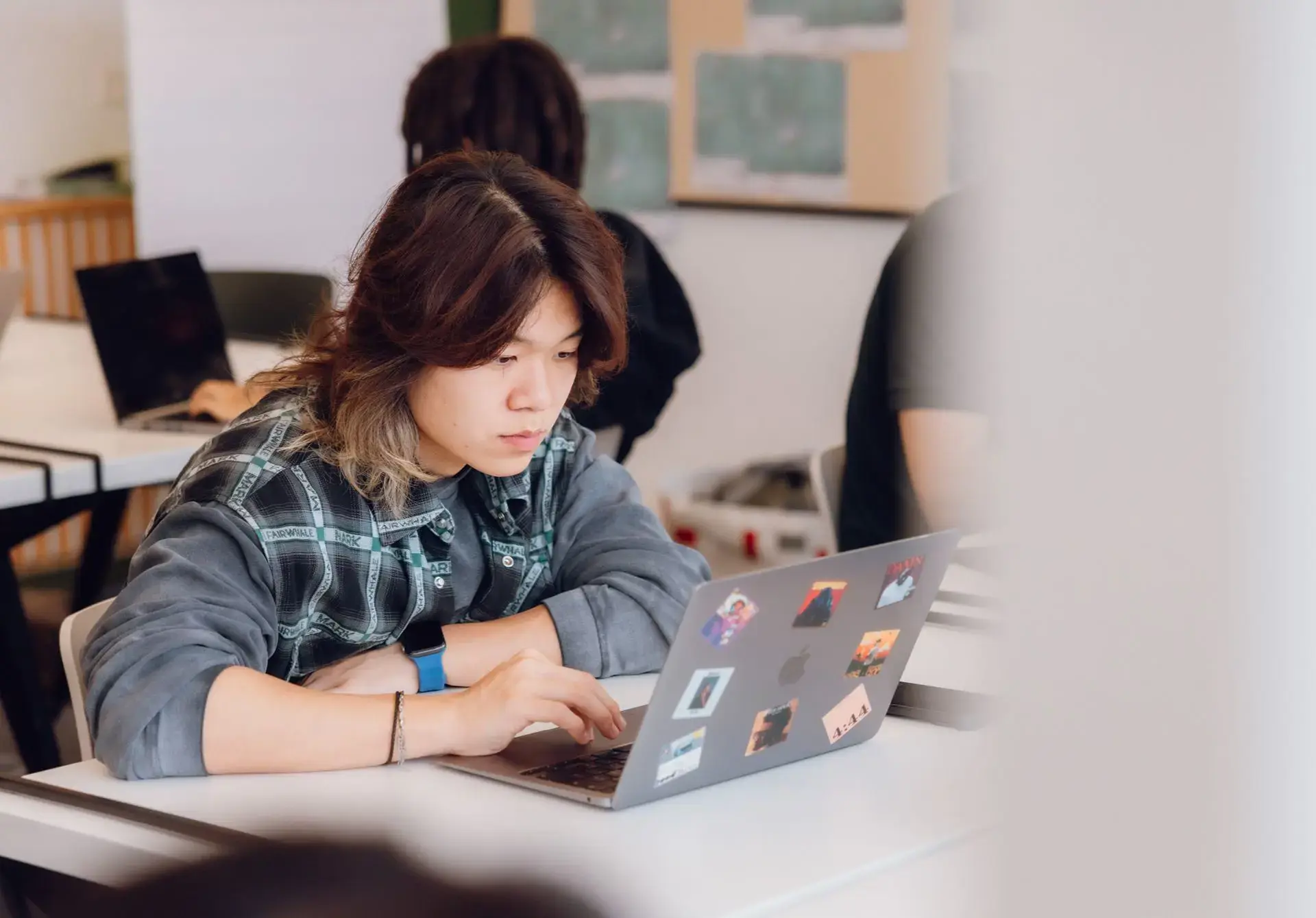 Student in class researching on a laptop