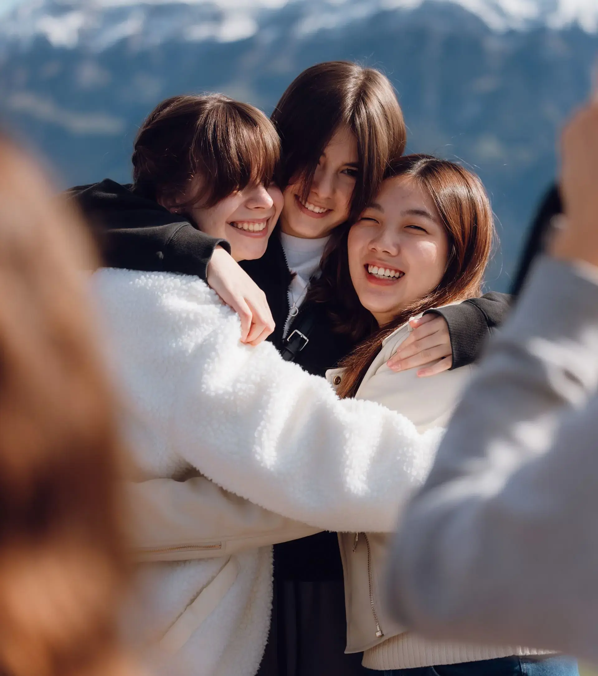 Group of students hugging each other for a photo during a hike