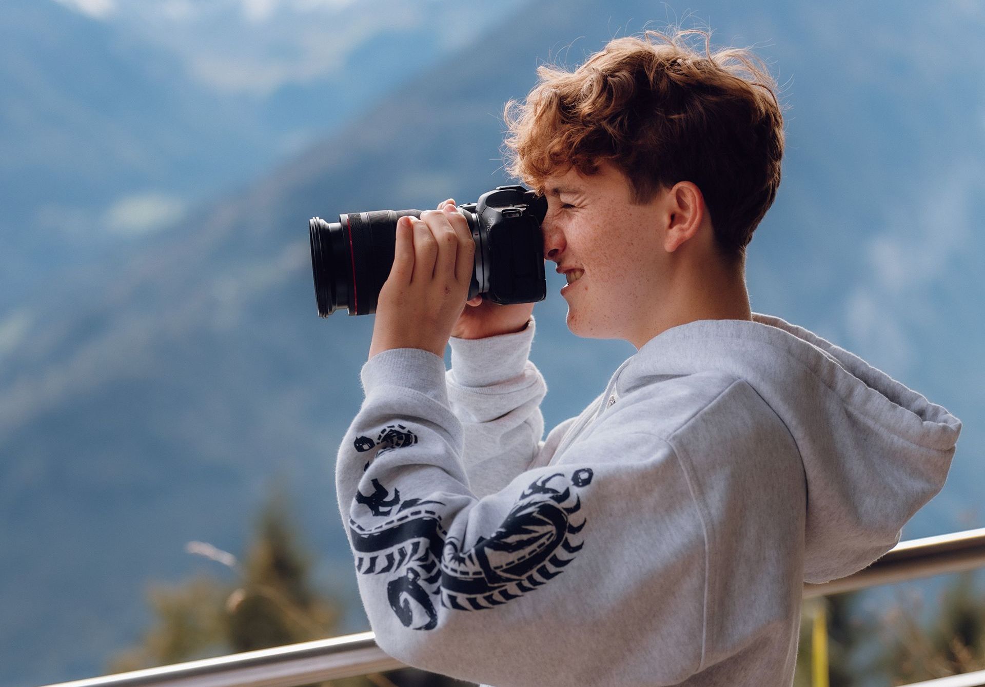 Student using a camara to take pictures outdoors