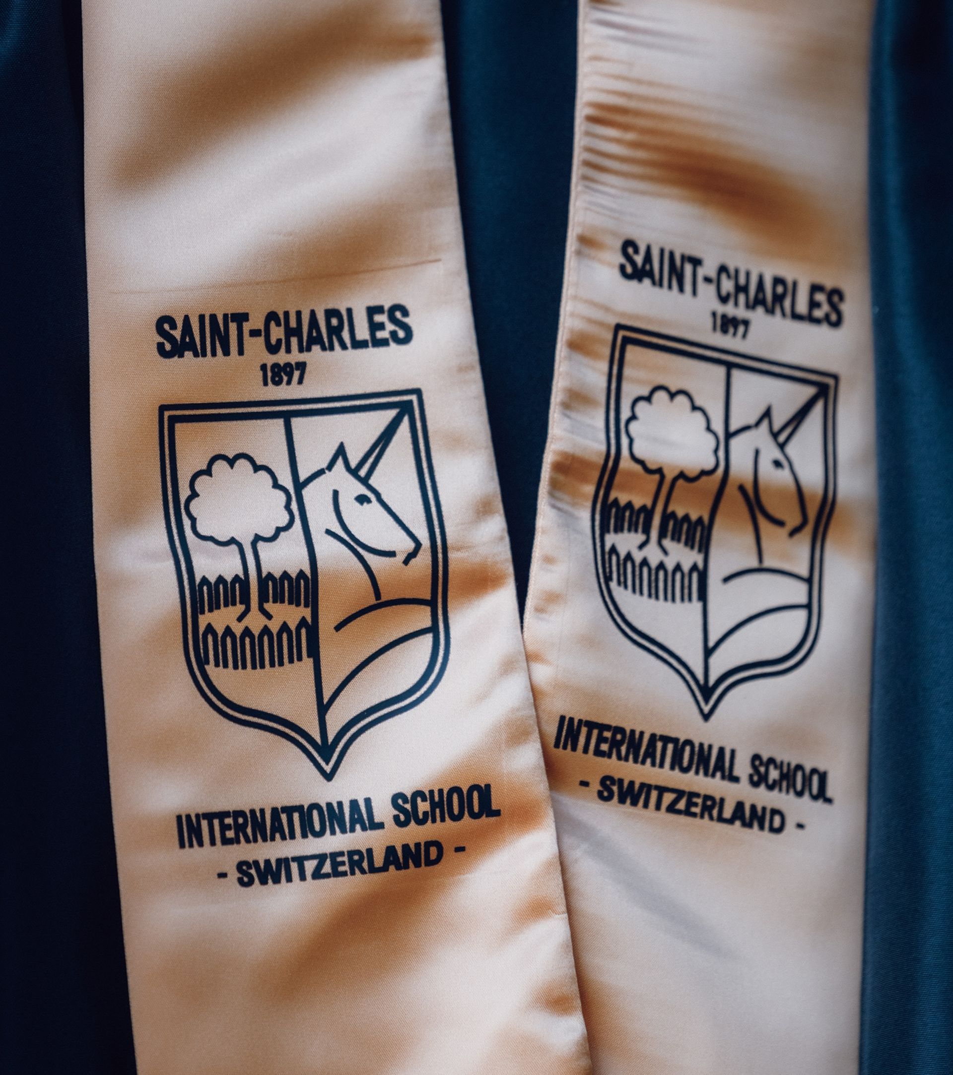 Graduation sash featuring the Saint Charles logo