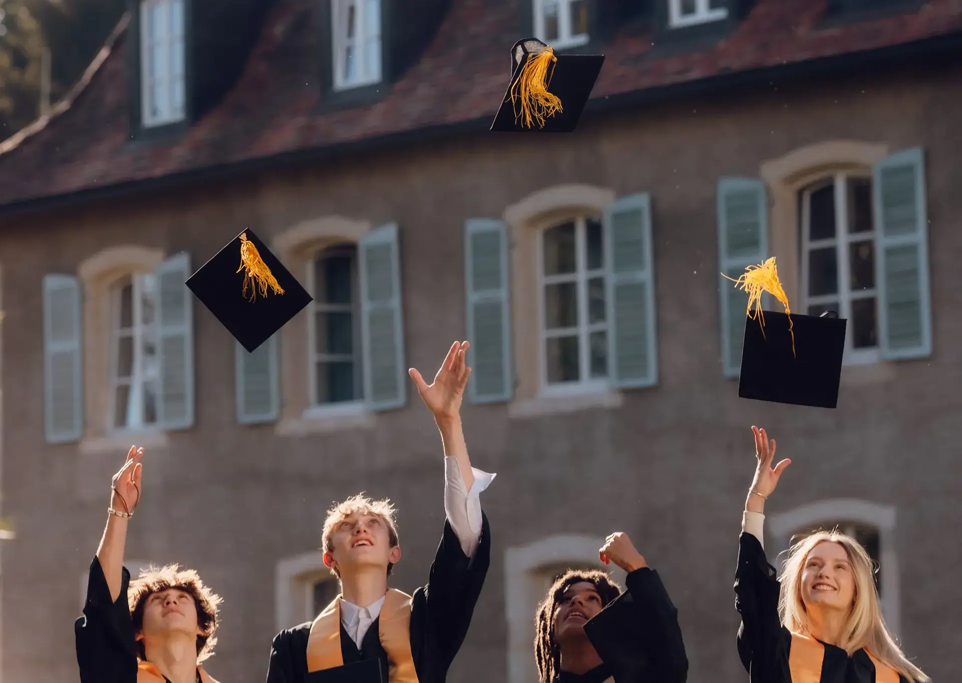 Students throwing their graduating caps in the air