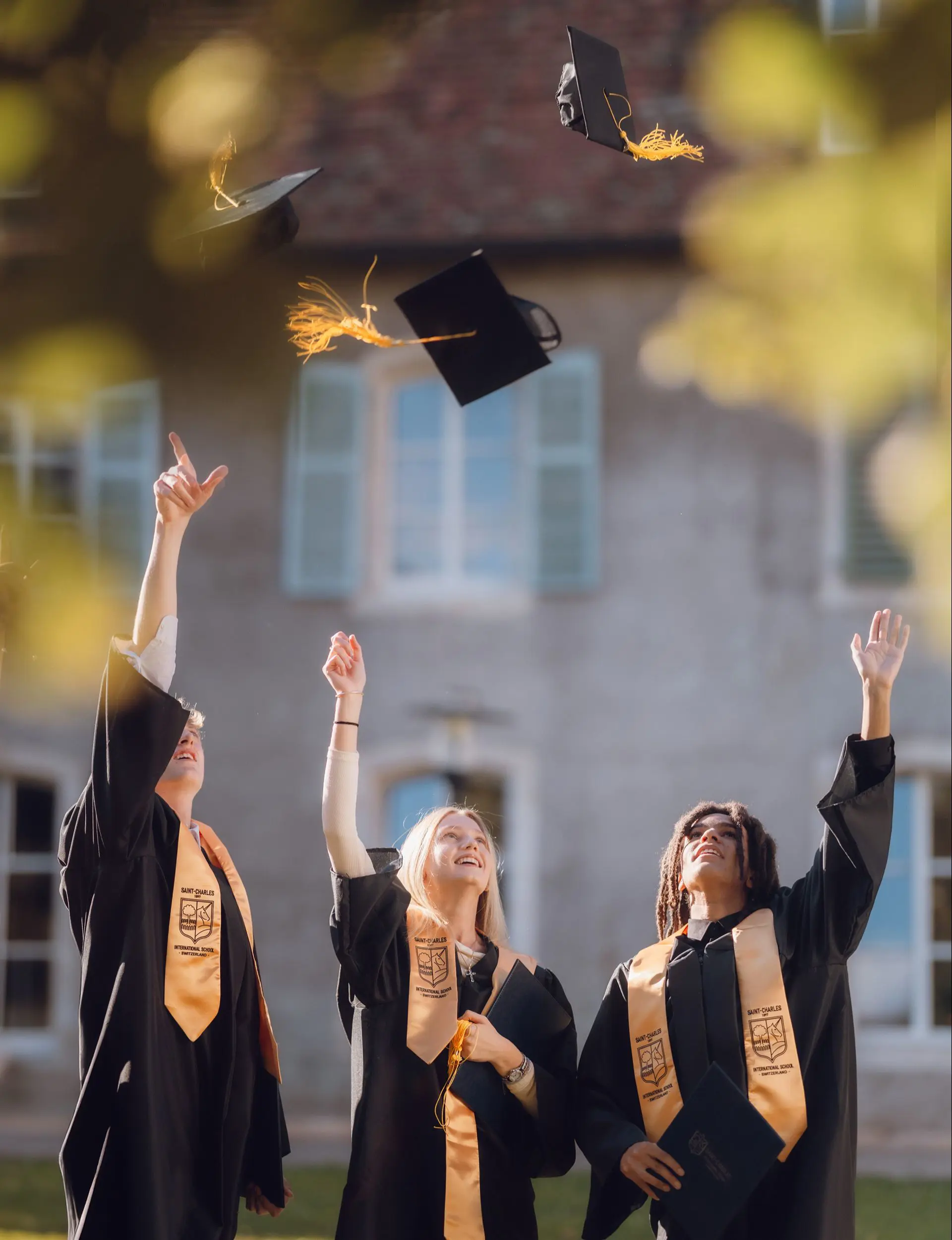 Students throwing their graduating caps in the air