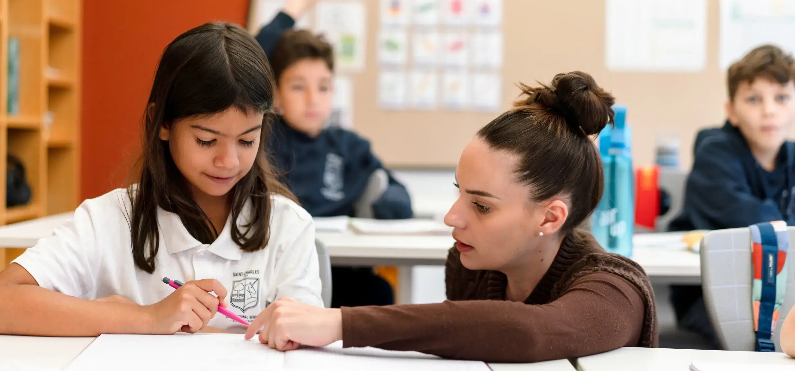 Teacher helping a student with course work