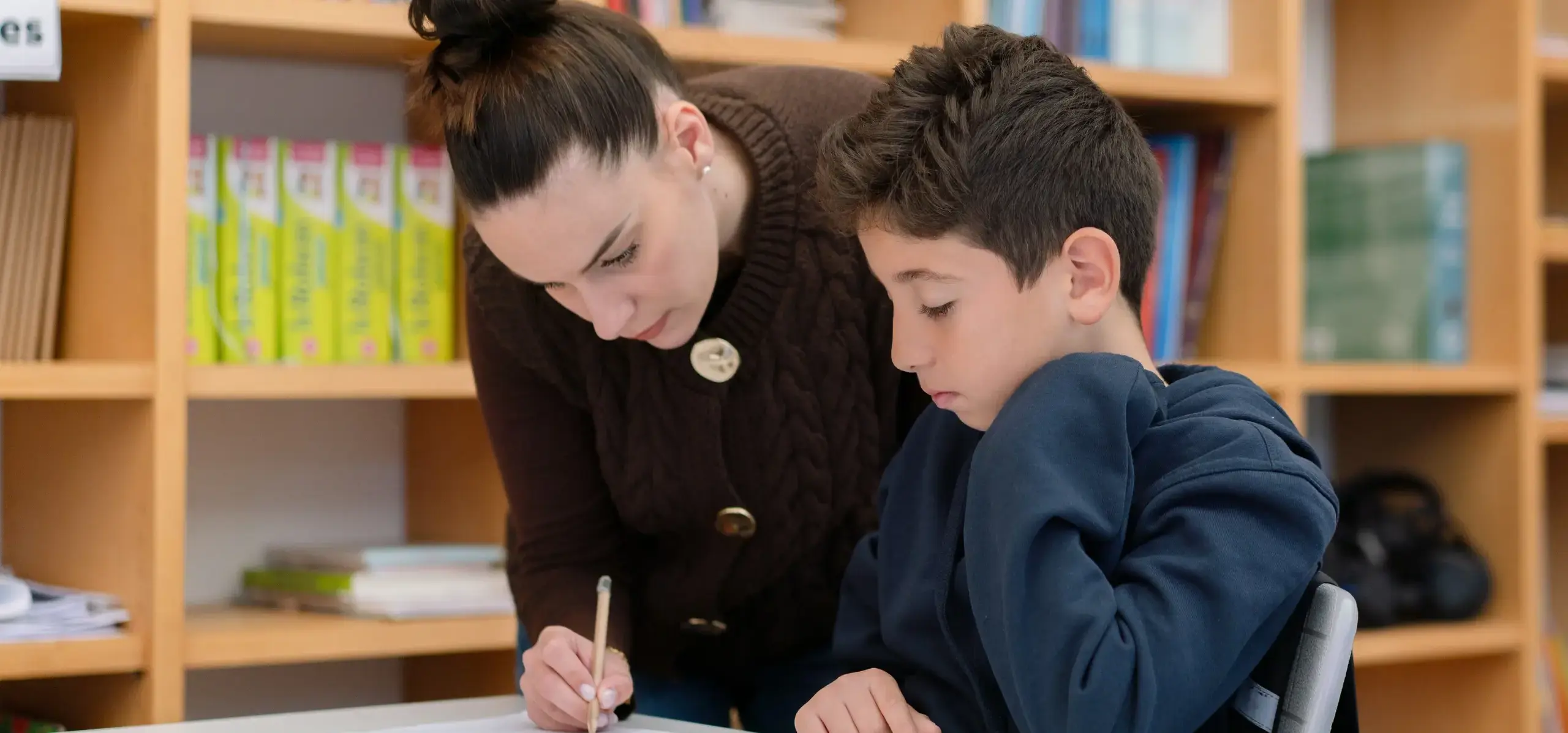 Teacher helping a student with course work