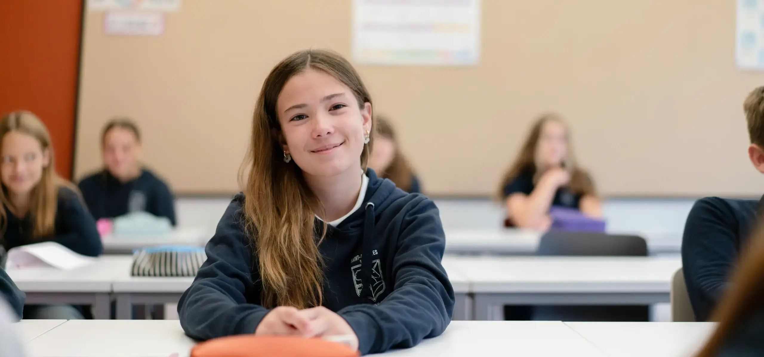 Students sitting at a desk in a classroom