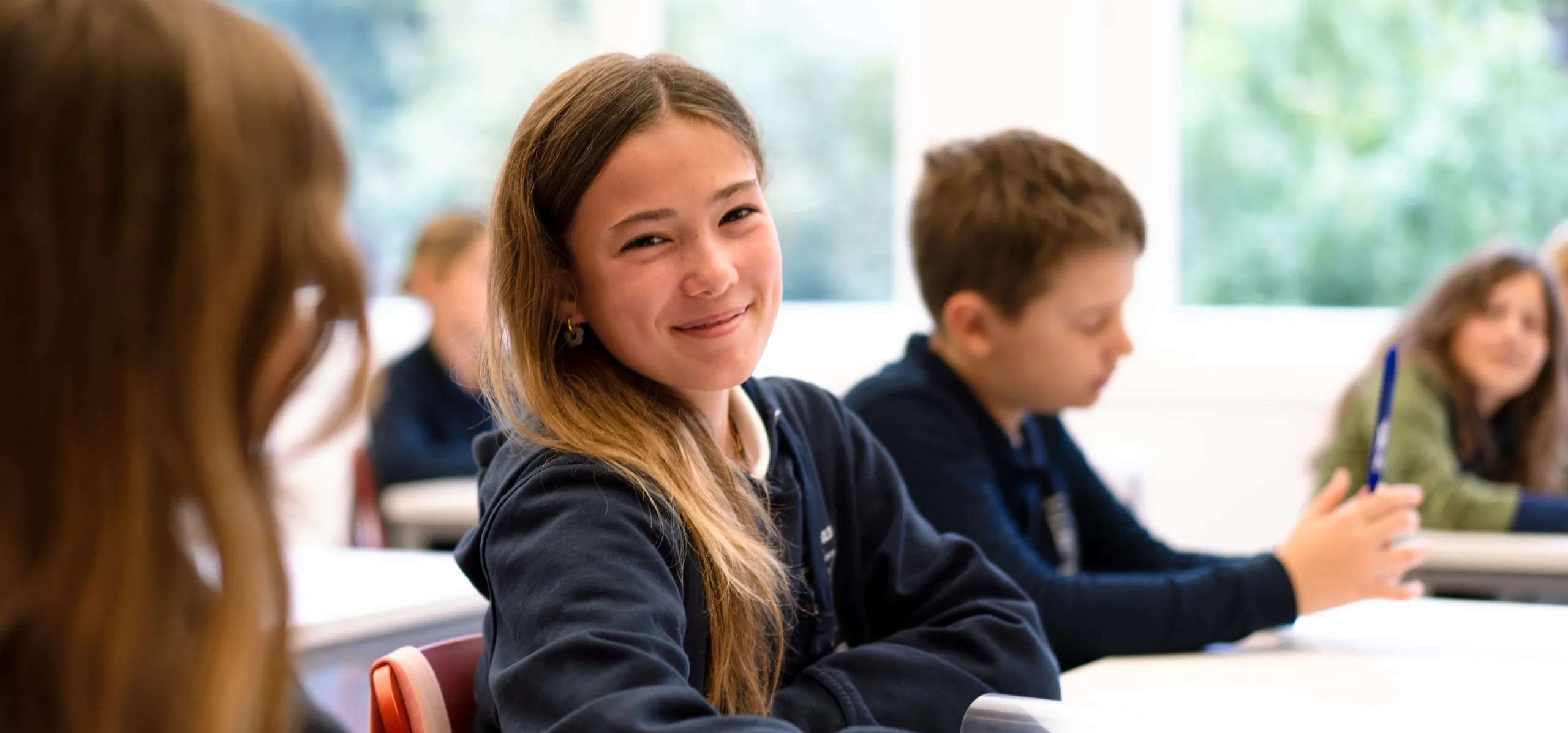 Students sitting at a desk in a classroom