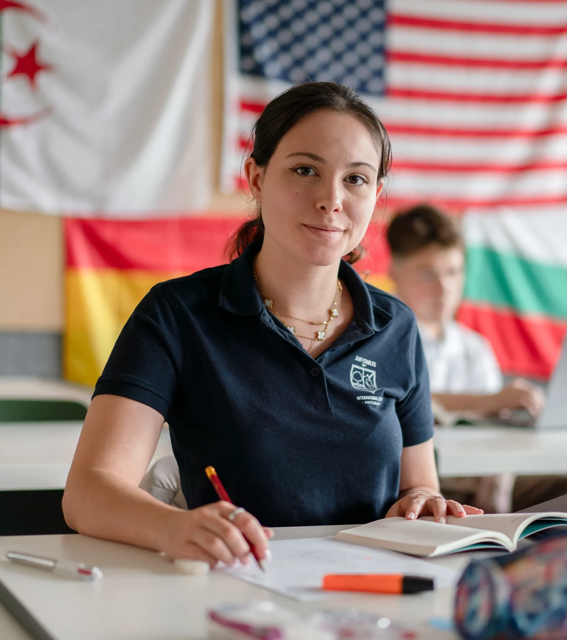 Student writing on her note book in class