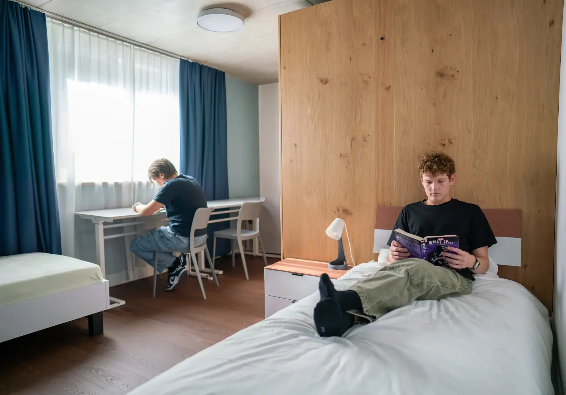 Students in their accommodation reading books