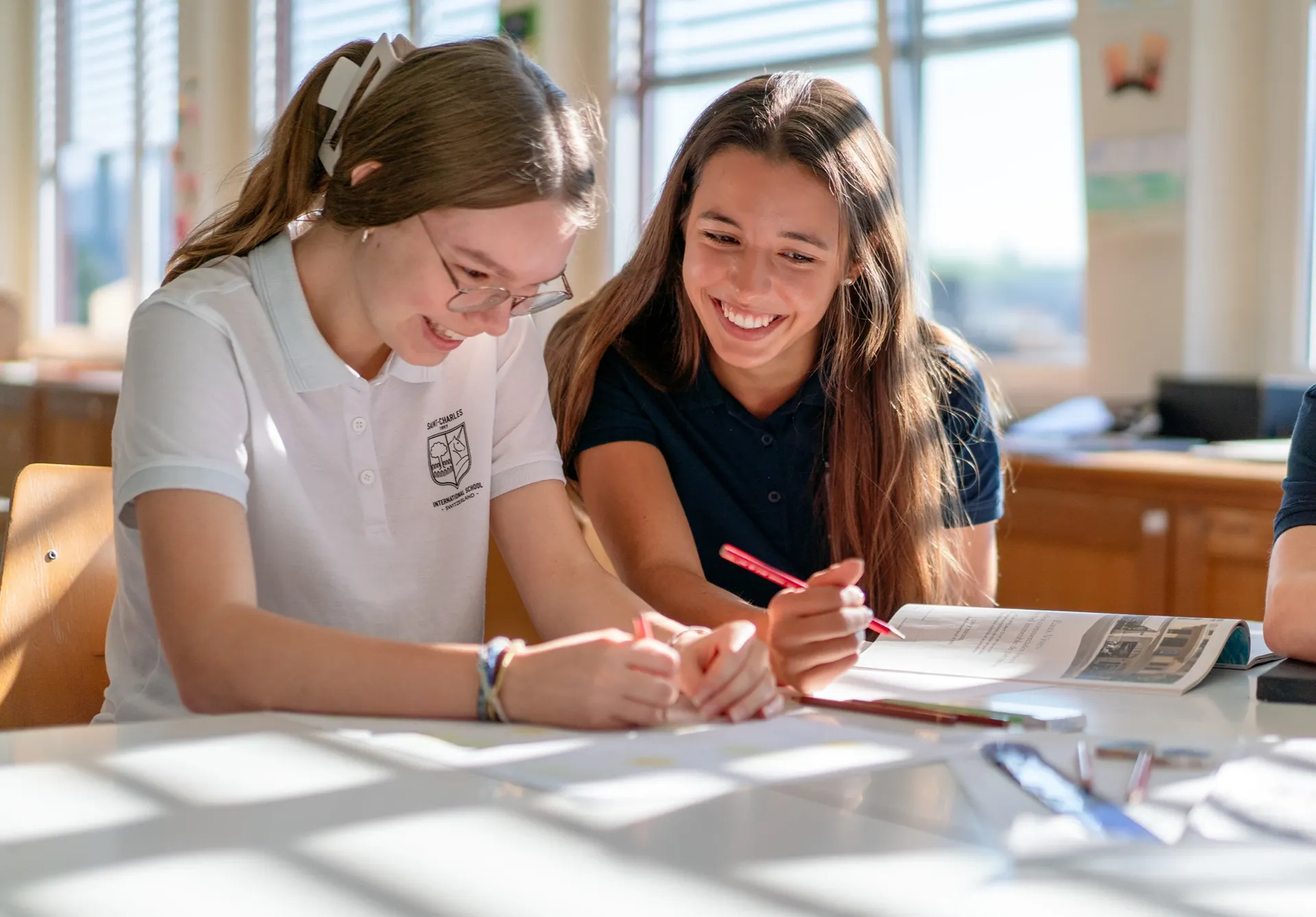 Students sitting at a desk doing course work 
