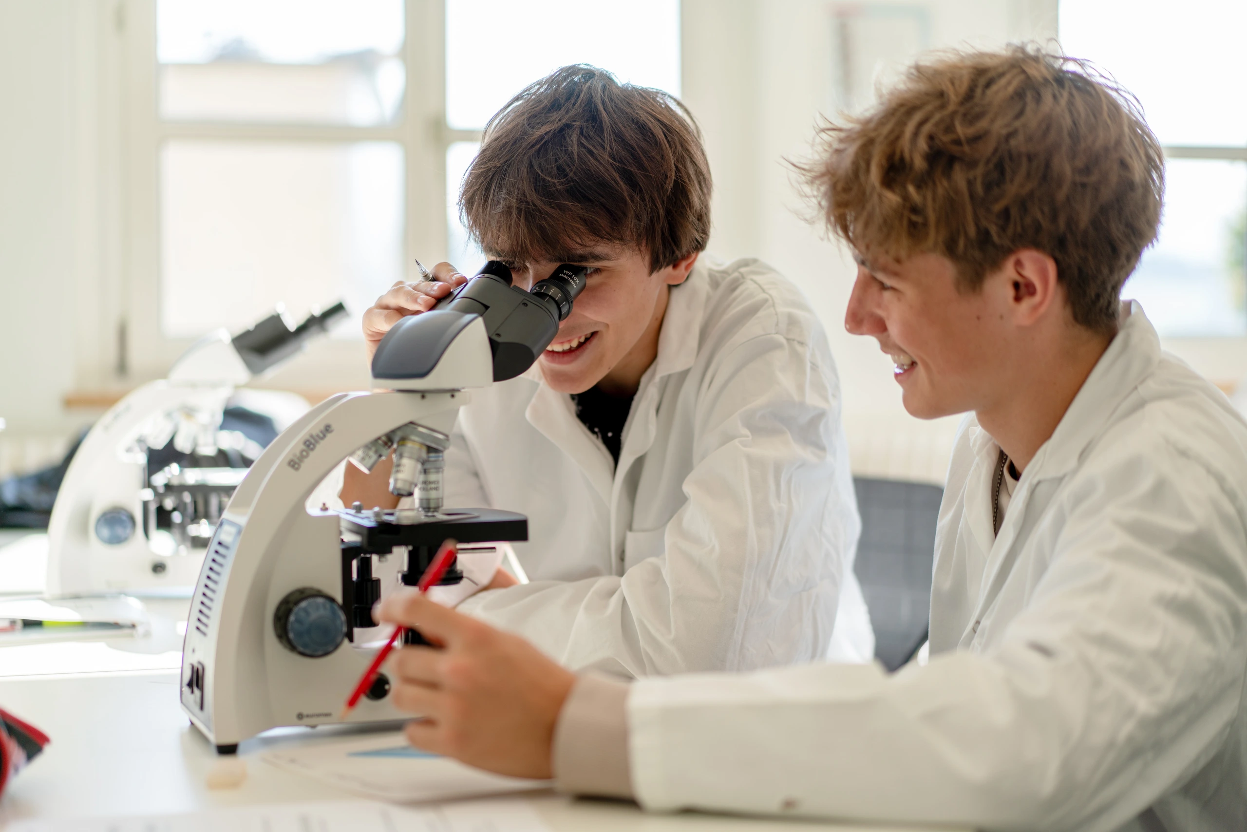Student looking through a microscope