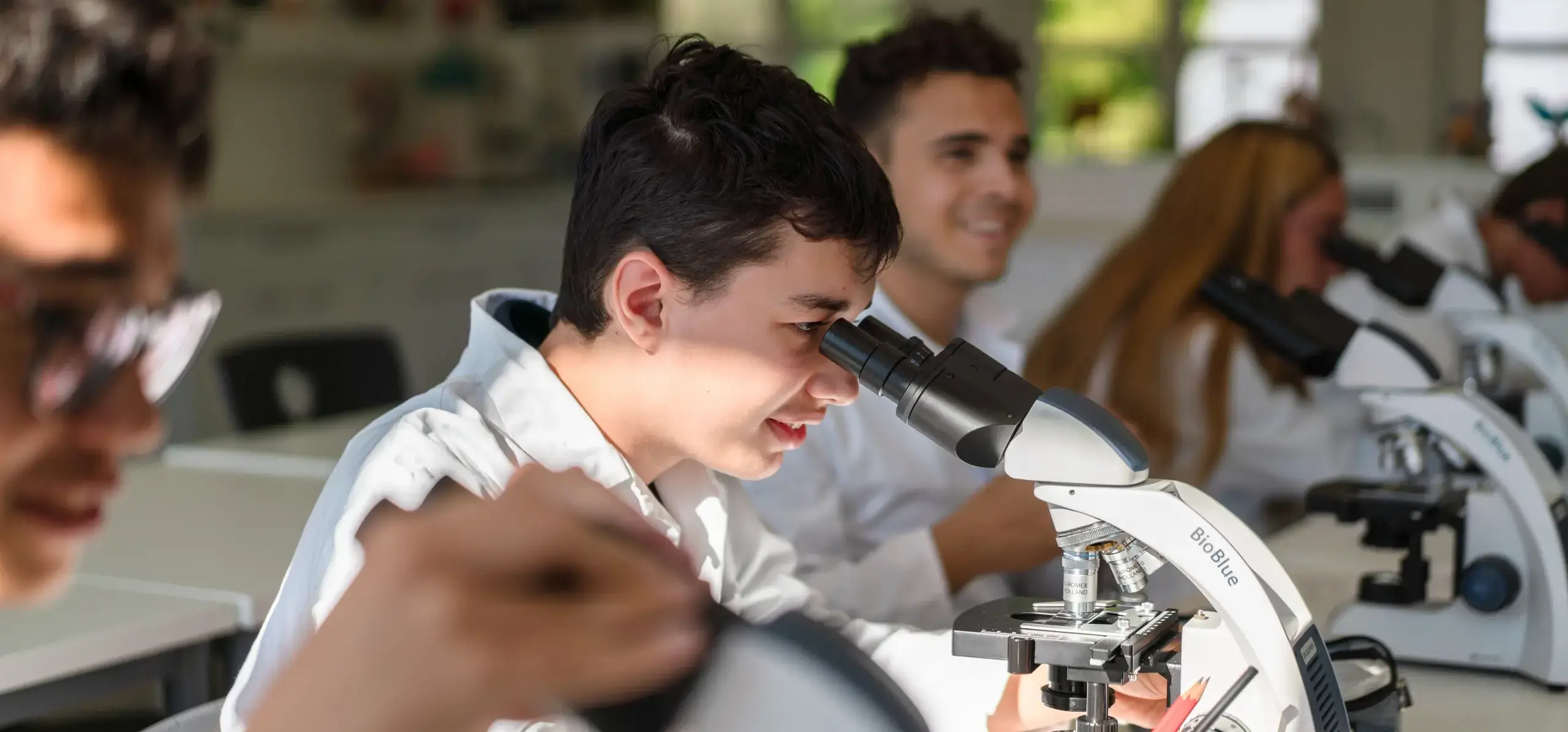 Student looking through a microscope